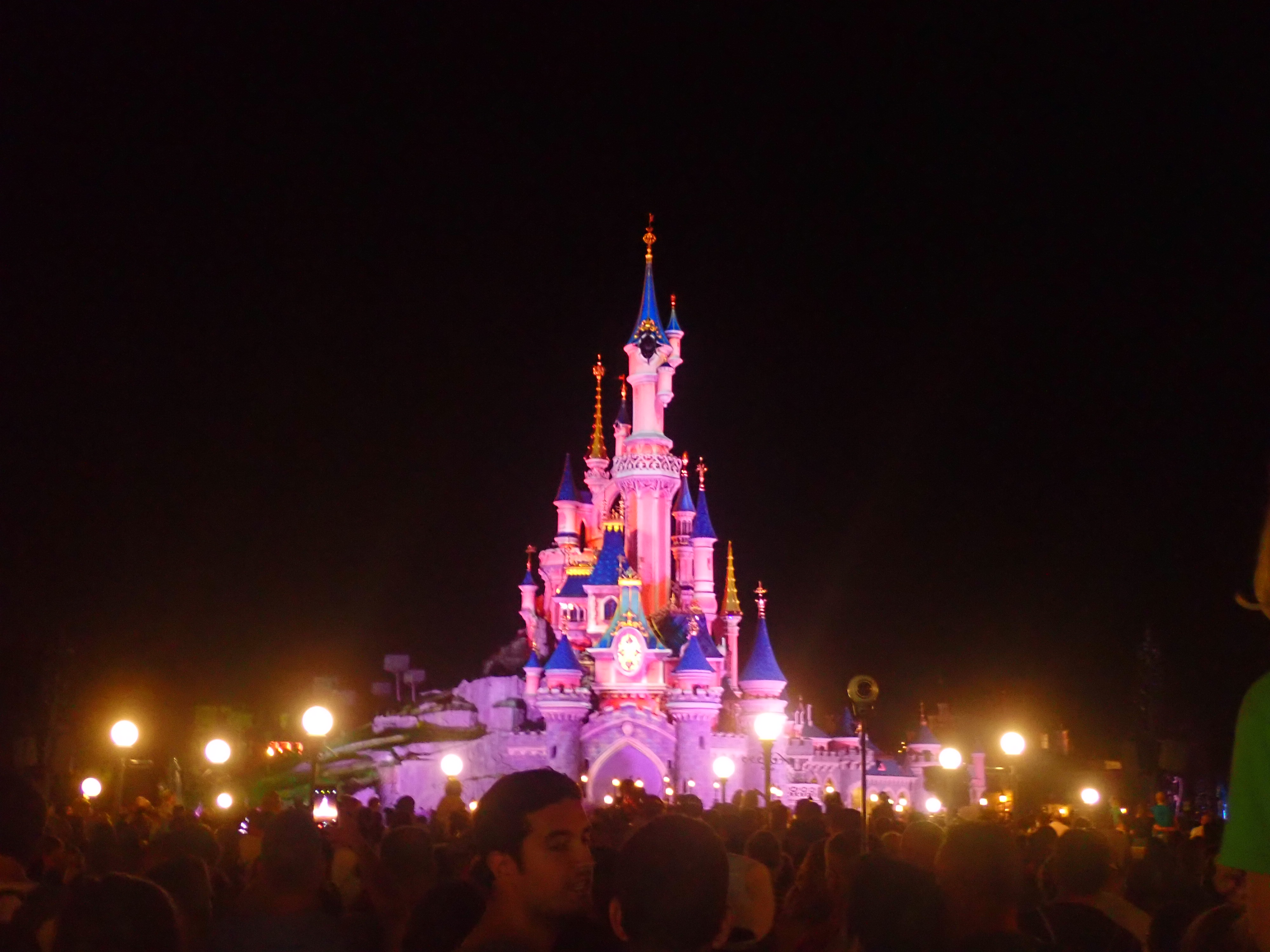 Disneyland Paris One Day Itinerary featured by top US Disney blogger, Marcie and the Mouse: The Disneyland Paris castle is all lit up at night during the Finale show