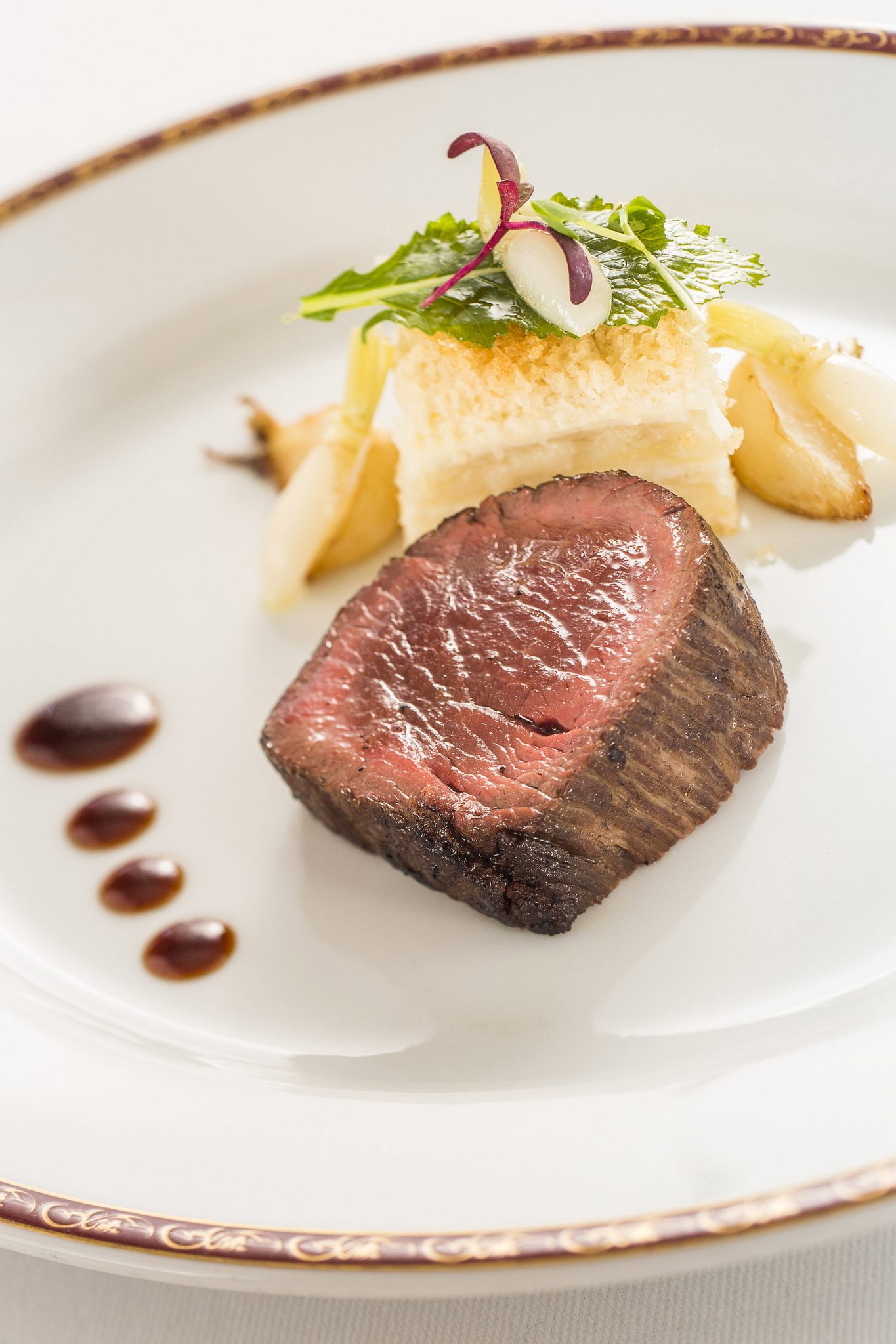 Top 10 Things to Do on Disney Fantasy featured by top US Disney blogger, Marcie and the Mouse: Kobe beef with turnip and potato gratin, served with thyme jus. Chef Arnaud Lallement, Remy (Matt Stroshane, photographer)